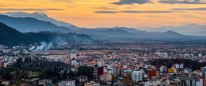 Preview wallpaper city, mountains, aerial view, buildings, clouds