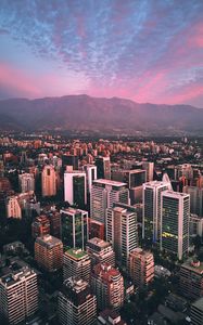 Preview wallpaper city, mountains, buildings, roofs, aerial view
