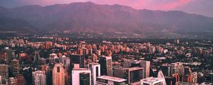 Preview wallpaper city, mountains, buildings, roofs, aerial view
