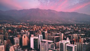 Preview wallpaper city, mountains, buildings, roofs, aerial view