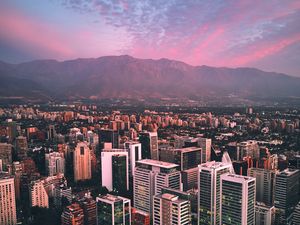 Preview wallpaper city, mountains, buildings, roofs, aerial view