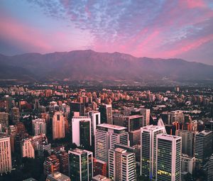 Preview wallpaper city, mountains, buildings, roofs, aerial view