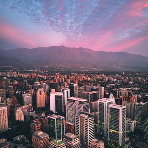 Preview wallpaper city, mountains, buildings, roofs, aerial view