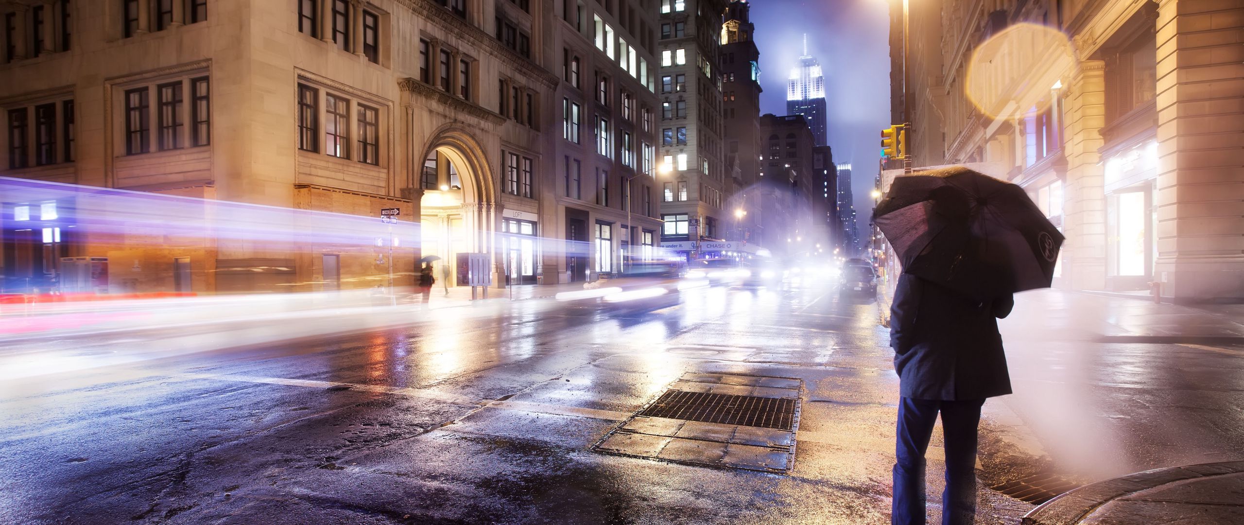 Download wallpaper 2560x1080 city, night, cloudy, lonely, man, umbrella