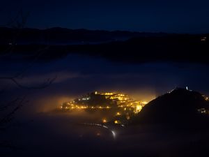 Preview wallpaper city, night, fog, light, mountains, rimini, italy