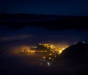 Preview wallpaper city, night, fog, light, mountains, rimini, italy