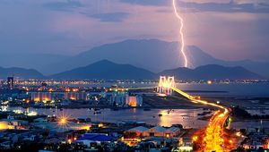 Preview wallpaper city, night, lights, mountains, lightning