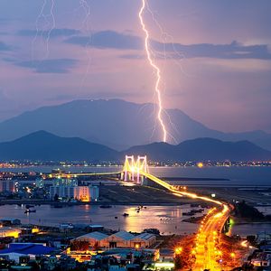 Preview wallpaper city, night, lights, mountains, lightning