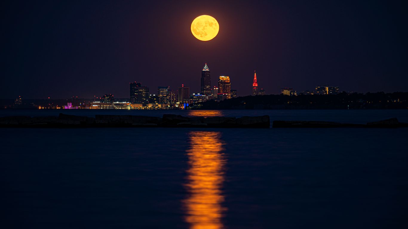 Download wallpaper 1366x768 city, night, moon, buildings, water