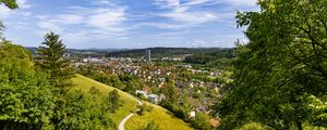 Preview wallpaper city, panorama, hills, trees, forest, sky, clouds
