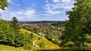 Preview wallpaper city, panorama, hills, trees, forest, sky, clouds