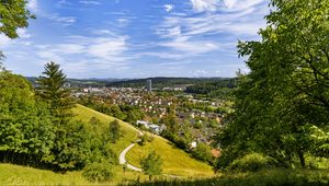 Preview wallpaper city, panorama, hills, trees, forest, sky, clouds