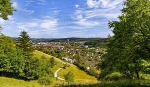 Preview wallpaper city, panorama, hills, trees, forest, sky, clouds