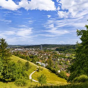 Preview wallpaper city, panorama, hills, trees, forest, sky, clouds