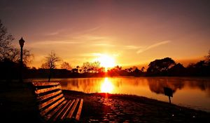 Preview wallpaper city, park, sunset, bench, landscape, light