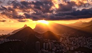 Preview wallpaper city, peaks, sunset, sun