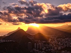 Preview wallpaper city, peaks, sunset, sun