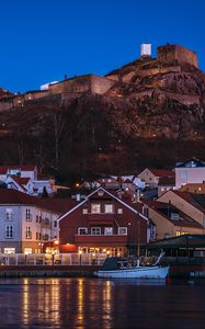 Preview wallpaper city, pier, rocks, evening, lights
