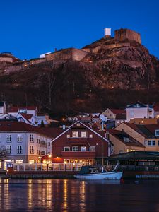 Preview wallpaper city, pier, rocks, evening, lights
