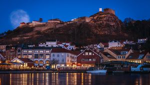 Preview wallpaper city, pier, rocks, evening, lights