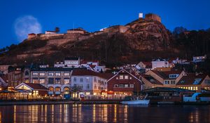 Preview wallpaper city, pier, rocks, evening, lights