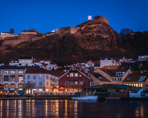 Preview wallpaper city, pier, rocks, evening, lights