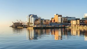Preview wallpaper city, pier, water, reflection, buildings