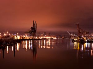 Preview wallpaper city, port, cranes, lights, light, reflection