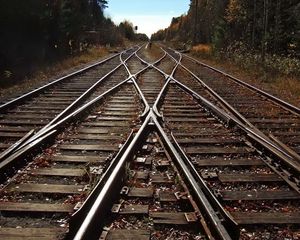 Preview wallpaper city, railroad, road, trees