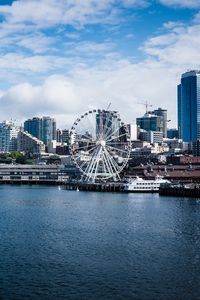 Preview wallpaper city, river, coast, buildings, ferris wheel, view