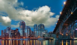 Preview wallpaper city, river, sea, water, clouds, sky, building, bridge, reflection