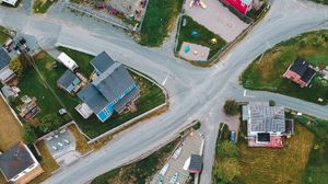 Preview wallpaper city, road, aerial view, rocks, sea