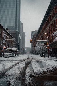 Preview wallpaper city, road, buildings, snow, winter, bottom view