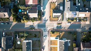 Preview wallpaper city, road, houses, aerial view
