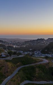 Preview wallpaper city, road, winding, horizon, evening