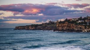 Preview wallpaper city, rocks, sea, waves, water