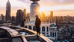 Preview wallpaper city, roof, loneliness, man, solitude, sunset, architecture