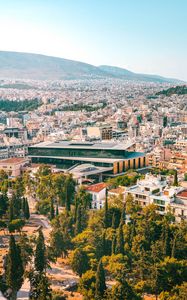 Preview wallpaper city, roofs, mountains, trees