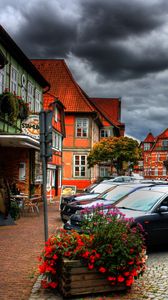 Preview wallpaper city, sky, clouds, cars, houses, flowers, plants