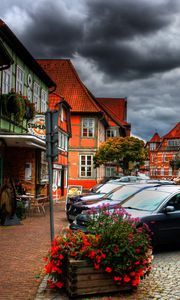 Preview wallpaper city, sky, clouds, cars, houses, flowers, plants