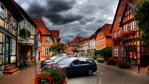 Preview wallpaper city, sky, clouds, cars, houses, flowers, plants