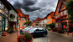 Preview wallpaper city, sky, clouds, cars, houses, flowers, plants