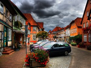 Preview wallpaper city, sky, clouds, cars, houses, flowers, plants