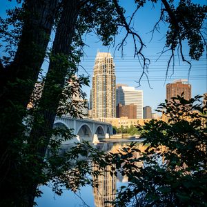 Preview wallpaper city, skyscrapers, bridge, river, reflection, trees, architecture