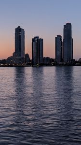 Preview wallpaper city, skyscrapers, buildings, water, evening