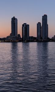 Preview wallpaper city, skyscrapers, buildings, water, evening