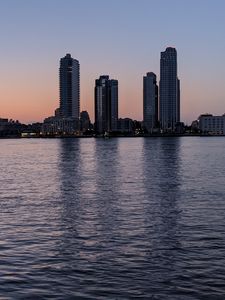 Preview wallpaper city, skyscrapers, buildings, water, evening