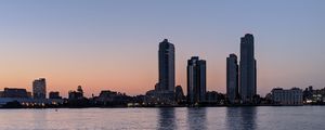 Preview wallpaper city, skyscrapers, buildings, water, evening