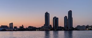 Preview wallpaper city, skyscrapers, buildings, water, evening