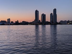 Preview wallpaper city, skyscrapers, buildings, water, evening